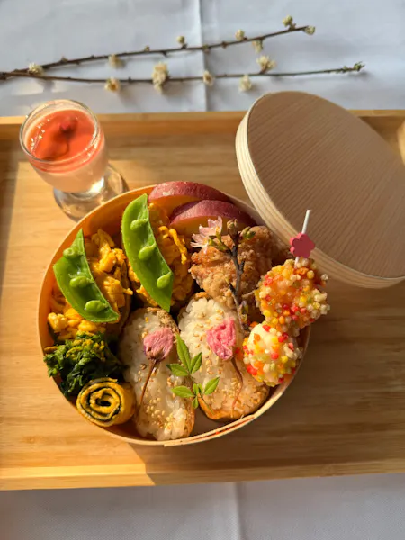 A colorful bento filled with a variety of Japanese dishes