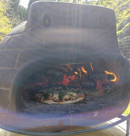Making pizzas in a wood-fired oven